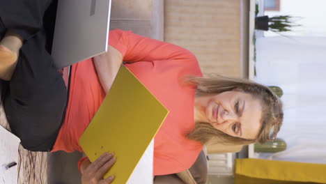 Vertical-video-of-The-woman-looking-at-the-documents-is-thoughtful.